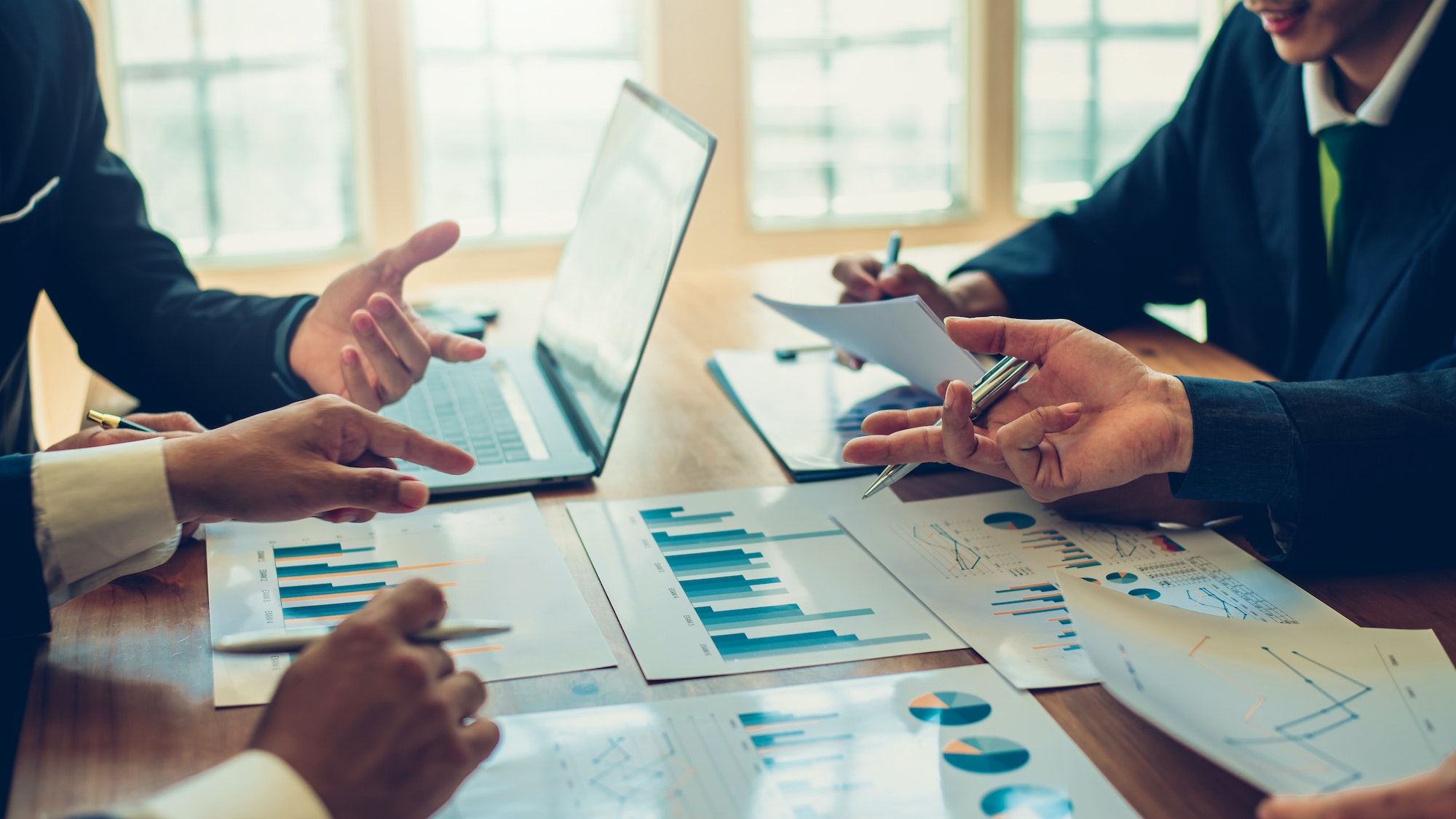 Business people gather to analyze marketing and investment information
